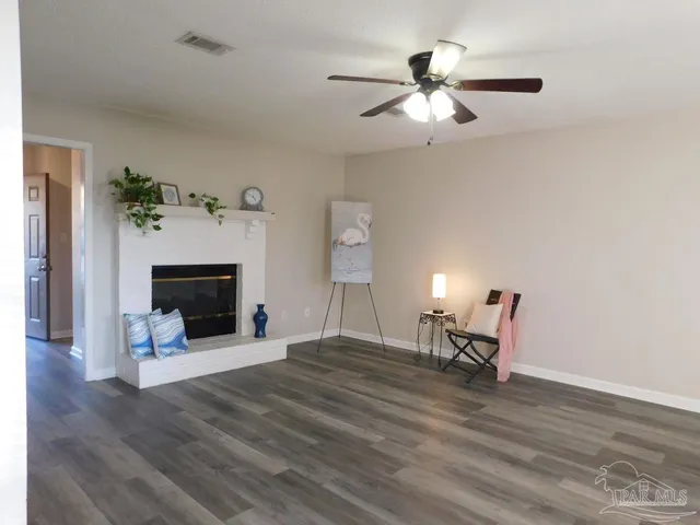 a view of livingroom with furniture and a fireplace