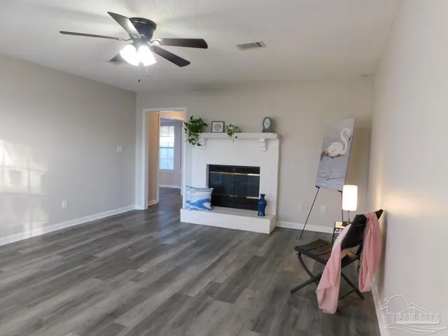 a view of a livingroom with furniture and a fireplace