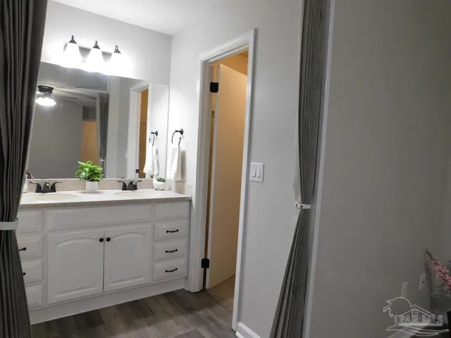 a bathroom with a double vanity sink and mirror