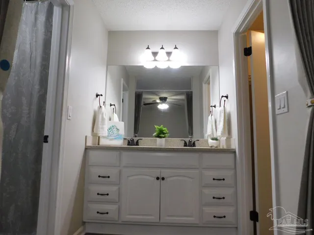 a bathroom with a sink vanity and a mirror