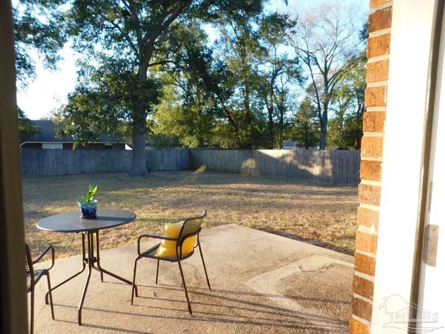 a view of yard with swimming pool and sitting area