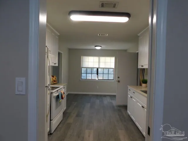 a bathroom with a double vanity sink toilet and tub