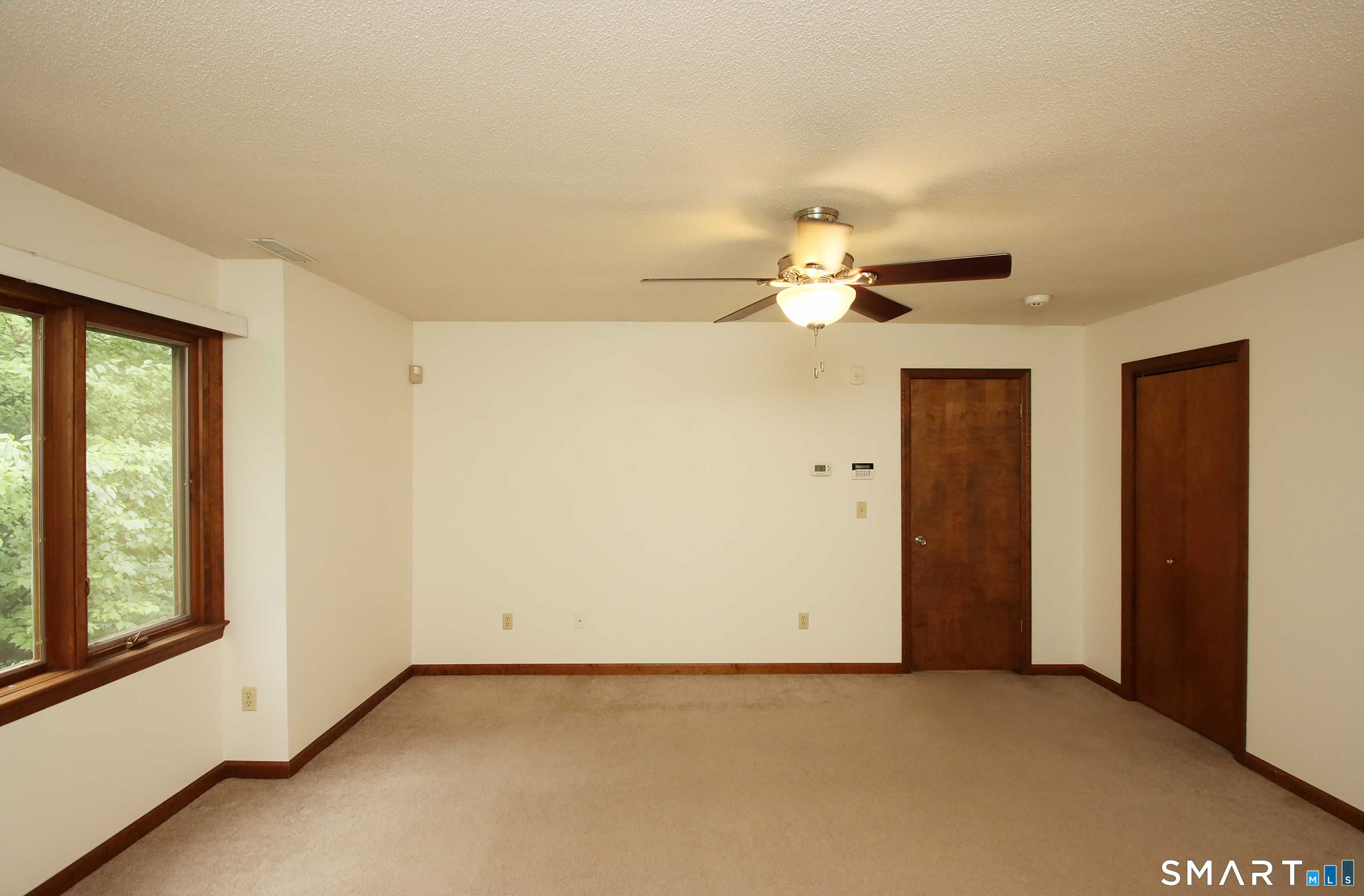352 Center Street Wolcott, CT 06716 - Photo 21 of 40 an empty room with a ceiling fan and a window