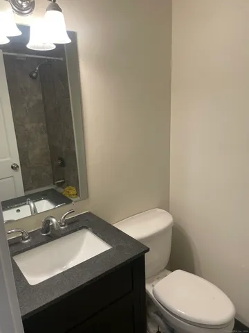 a bathroom with a sink toilet and mirror