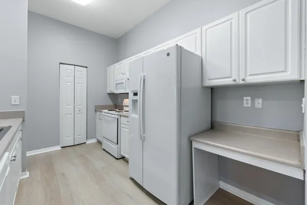 a kitchen with a sink and two window