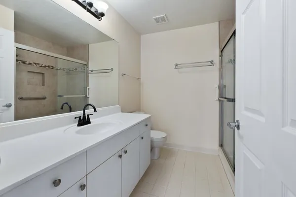 an empty room with windows and closet