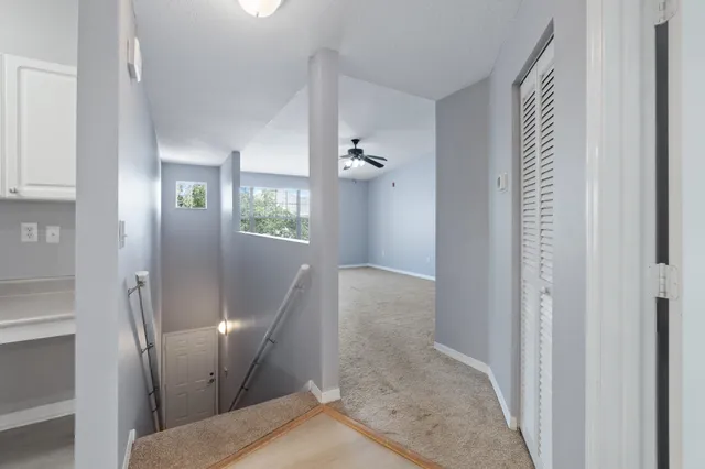 an empty room with kitchen and window