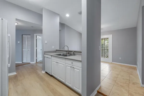 a bathroom with a sink and a refrigerator