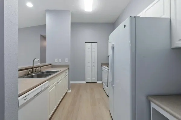 a kitchen with cabinets and stainless steel appliances