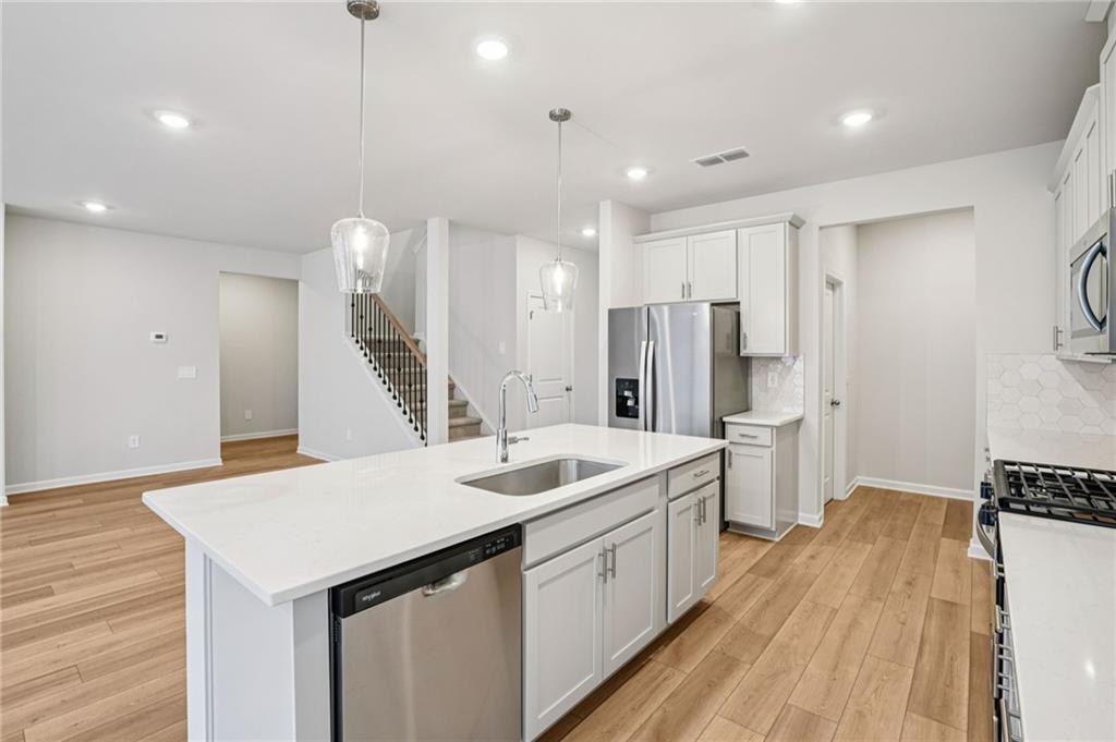6939 Winchester Place Fairburn, GA 30213 - Photo 17 of 56 a kitchen with a sink appliances and a counter top space