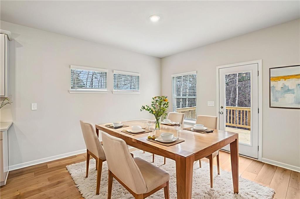 6939 Winchester Place Fairburn, GA 30213 - Photo 22 of 56 a view of a dining room with furniture and wooden floor