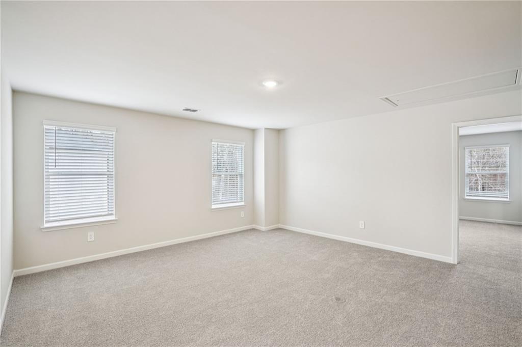 6939 Winchester Place Fairburn, GA 30213 - Photo 25 of 56 an empty room with windows