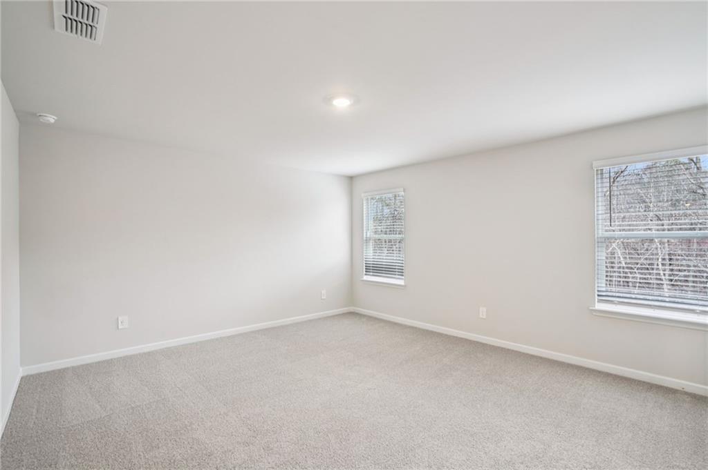 6939 Winchester Place Fairburn, GA 30213 - Photo 28 of 56 an empty room with windows