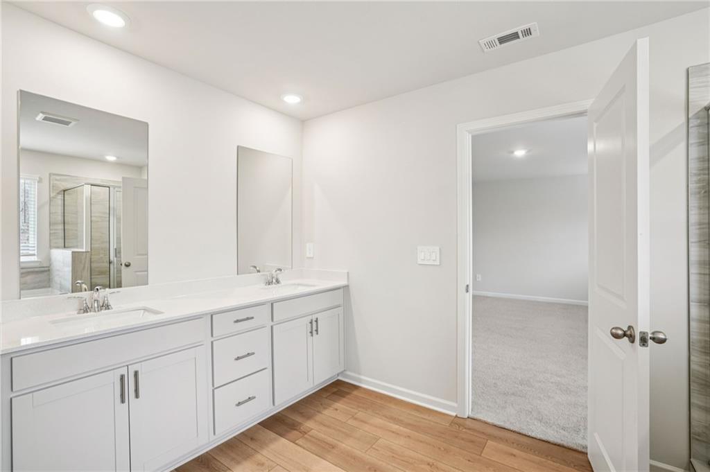 6939 Winchester Place Fairburn, GA 30213 - Photo 34 of 56 a bathroom with double sink and a mirror