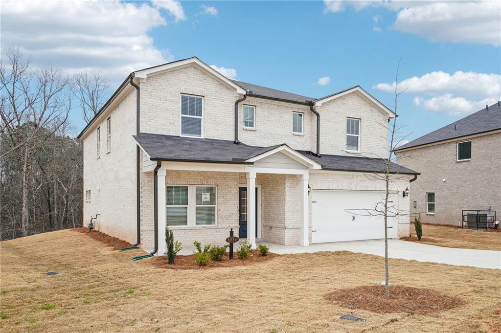 6939 Winchester Place Fairburn, GA 30213 - Photo 4 of 56 a front view of a house with a yard