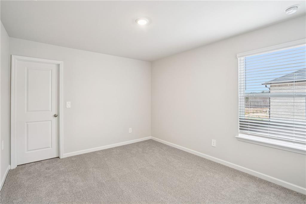 6939 Winchester Place Fairburn, GA 30213 - Photo 42 of 56 an empty room with a window