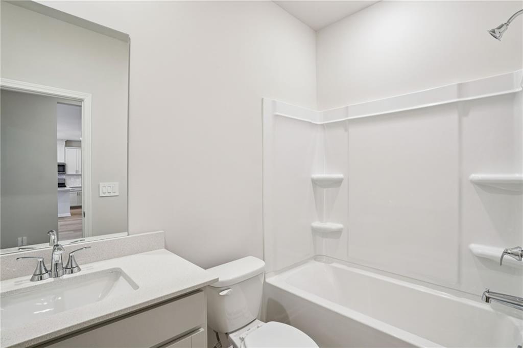 6939 Winchester Place Fairburn, GA 30213 - Photo 44 of 56 a bathroom with a sink toilet and shower