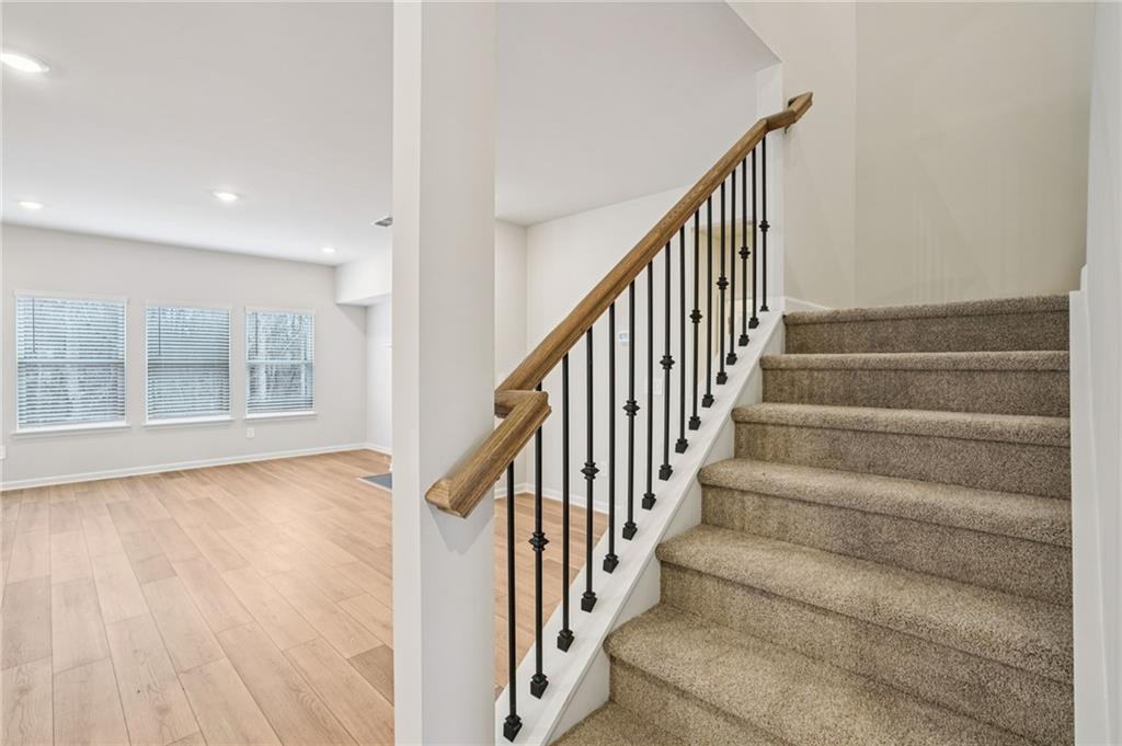 6939 Winchester Place Fairburn, GA 30213 - Photo 45 of 56 a view of an entryway with wooden floor and stairs