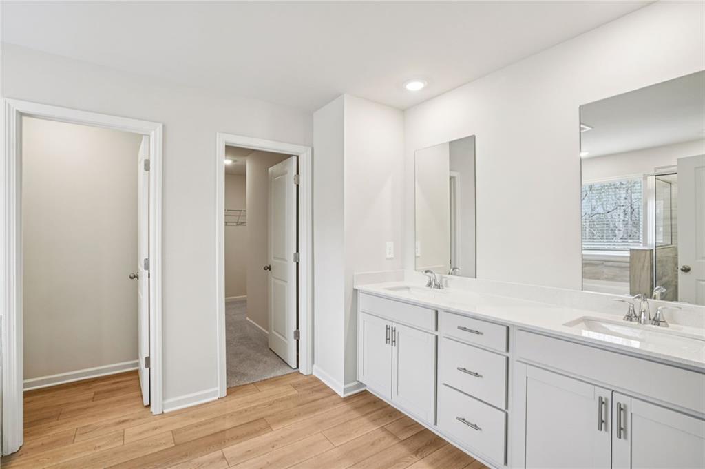 6939 Winchester Place Fairburn, GA 30213 - Photo 46 of 56 a spacious bathroom with double vanity a mirror and a shower