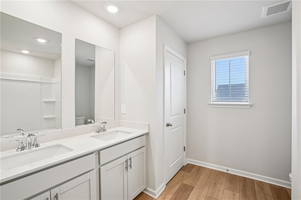 6939 Winchester Place Fairburn, GA 30213 - Photo 47 of 56 a bathroom with a sink and a mirror