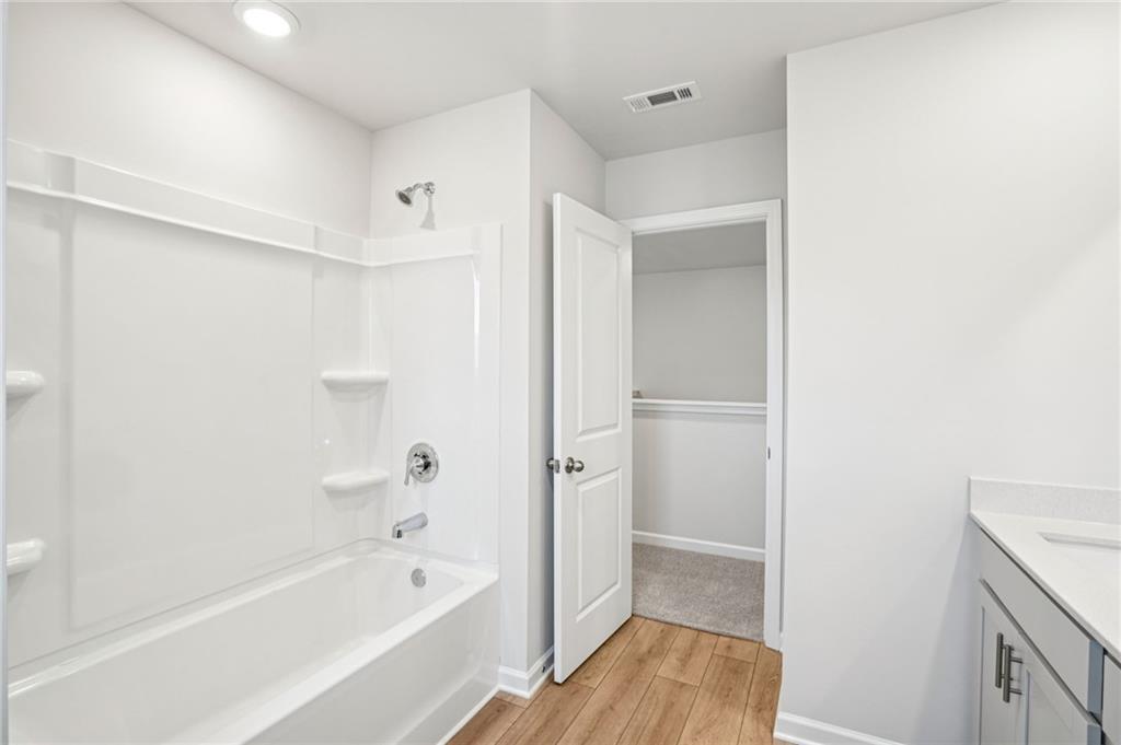 6939 Winchester Place Fairburn, GA 30213 - Photo 48 of 56 a bathroom with a bathtub and a shower