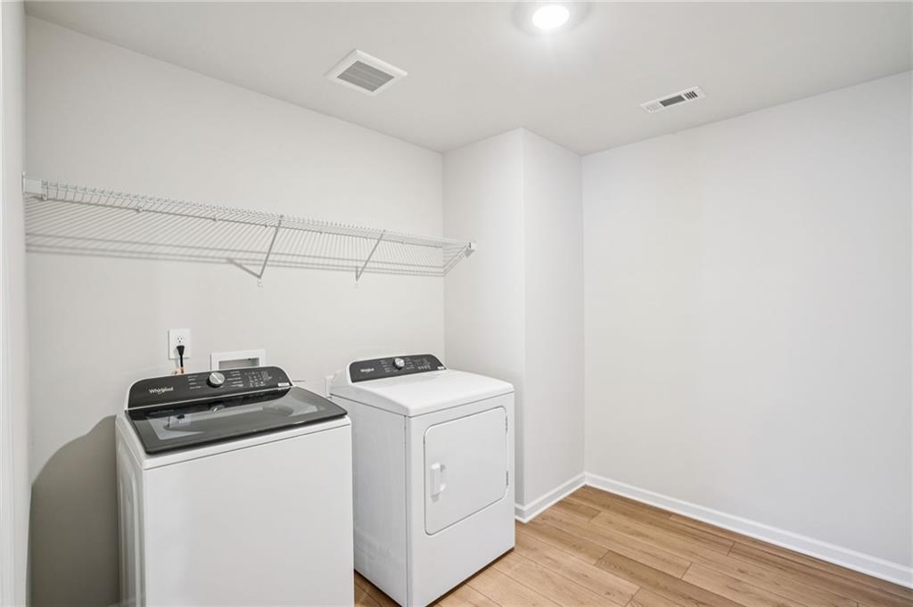 6939 Winchester Place Fairburn, GA 30213 - Photo 49 of 56 a utility room with dryer and washer