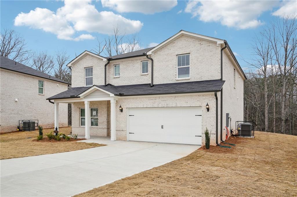6939 Winchester Place Fairburn, GA 30213 - Photo 5 of 56 a front view of a house with a yard