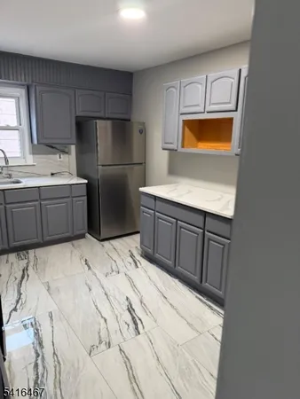 a kitchen with stainless steel appliances a refrigerator and a stove top oven