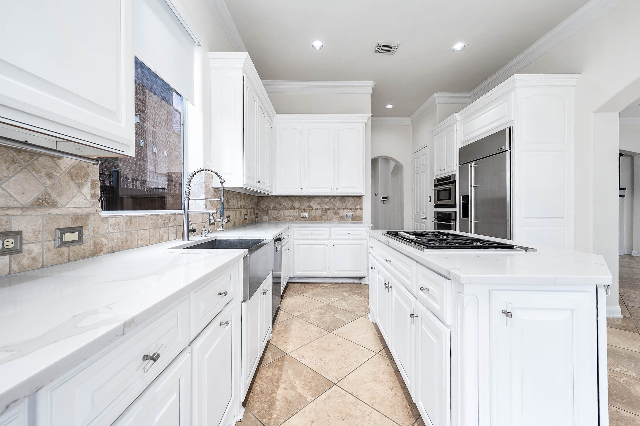 3323 Louvre Lane Houston, TX 77082 - Photo 24 of 50 a large white kitchen with stainless steel appliances granite countertop a sink and cabinets