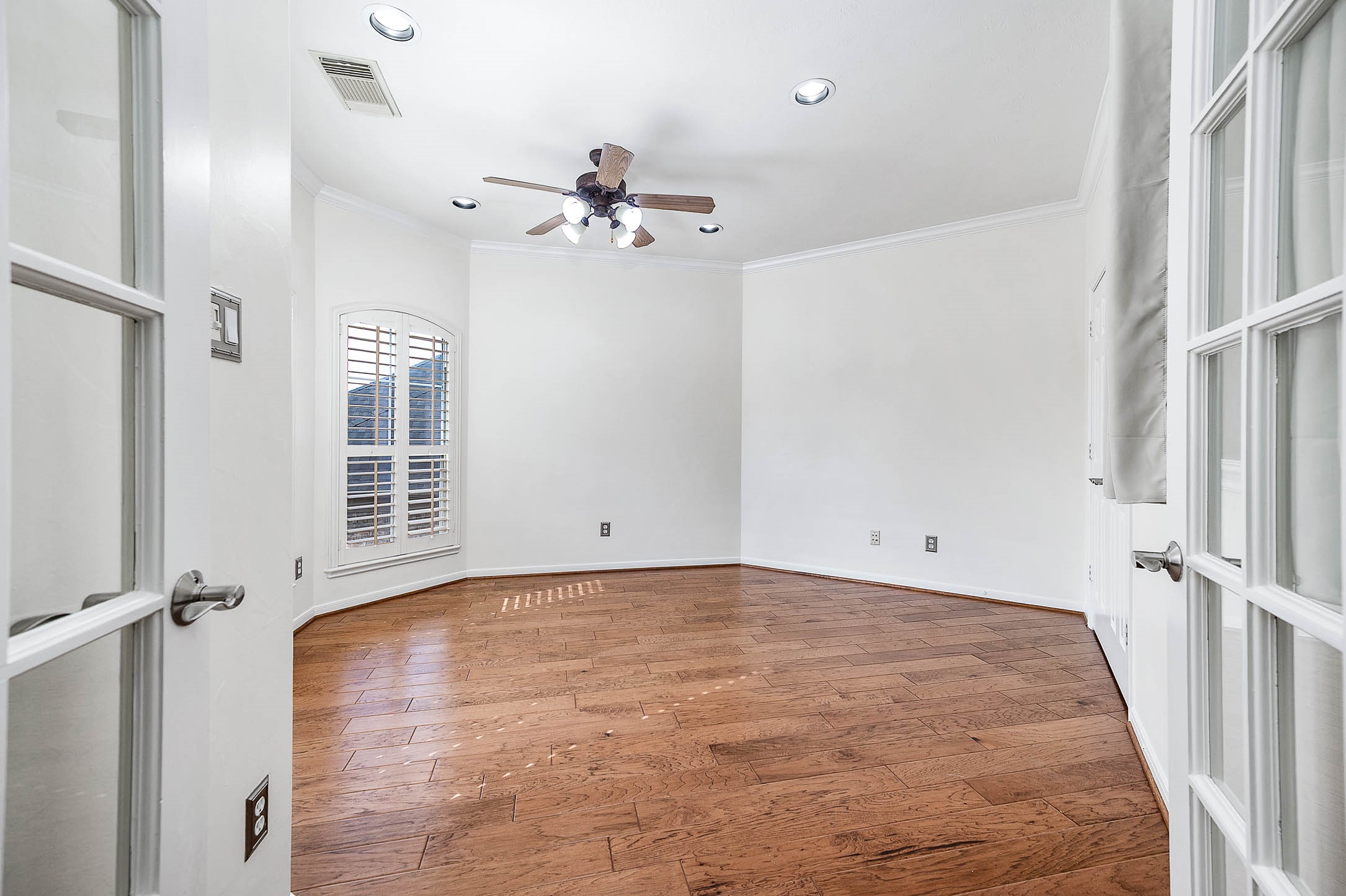3323 Louvre Lane Houston, TX 77082 - Photo 36 of 50 a view of a room with a ceiling fan and wooden floor