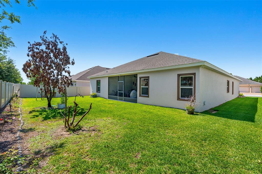 2085 Lula Road Minneola, FL 34715 - Photo 6 of 39 a view of a house with backyard and a tree