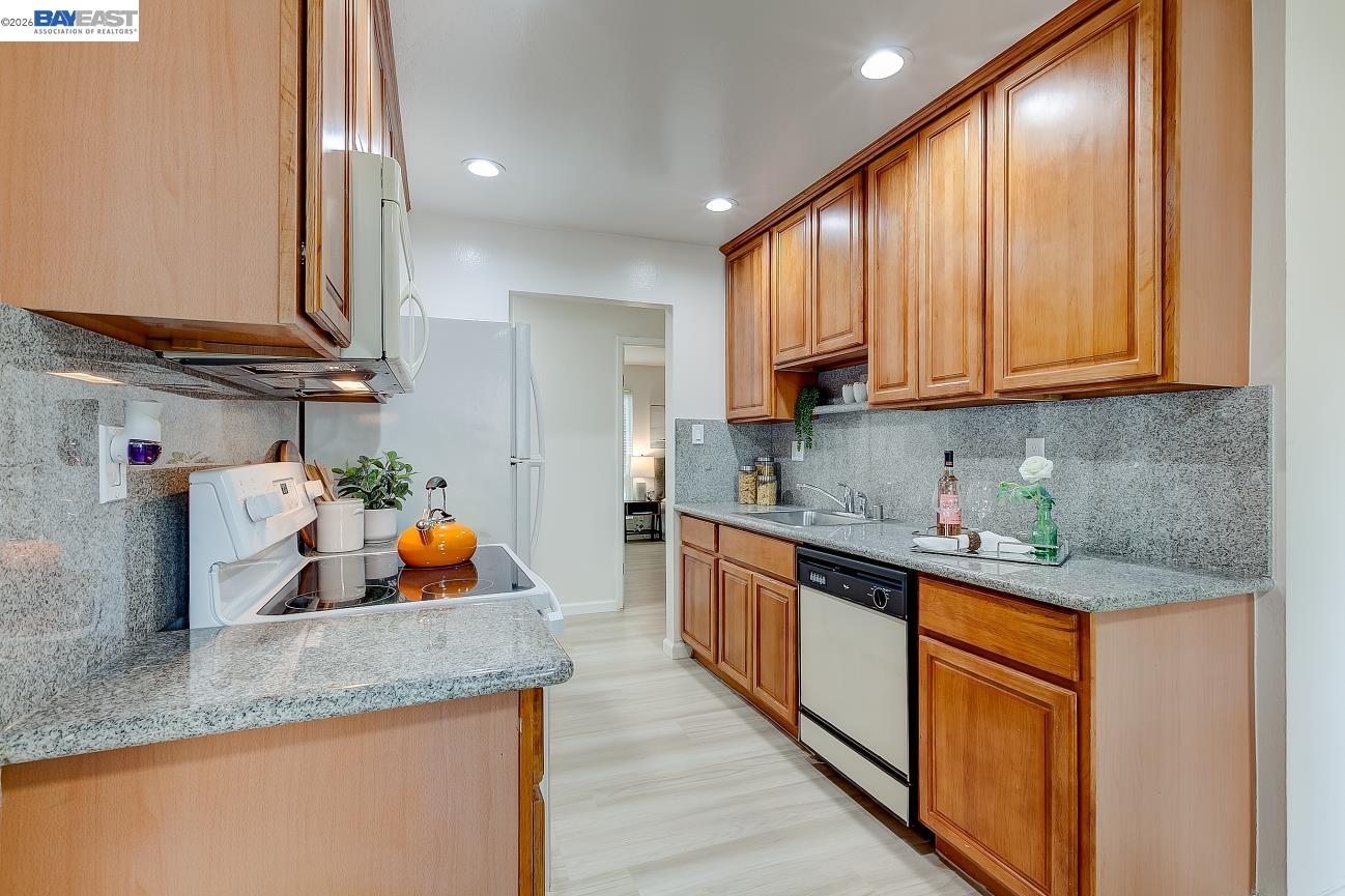 9005 Alcosta Boulevard, Unit 199 San Ramon, CA 94583 - Photo 24 of 57 a kitchen with stainless steel appliances granite countertop a sink stove and cabinets