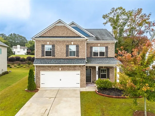 a front view of a house with garden