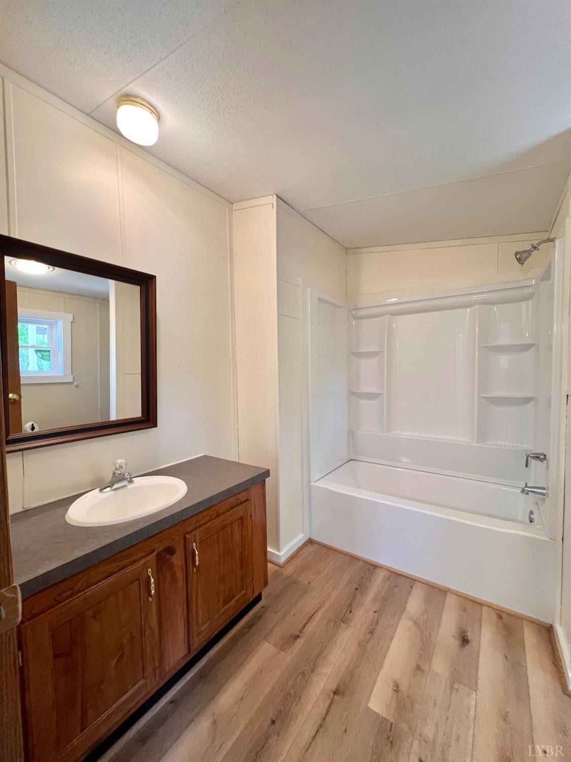 2107 Boxwood Farm Road Amherst, VA 24521 - Photo 11 of 33 a spacious bathroom with a granite countertop sink a toilet mirror and bathtub