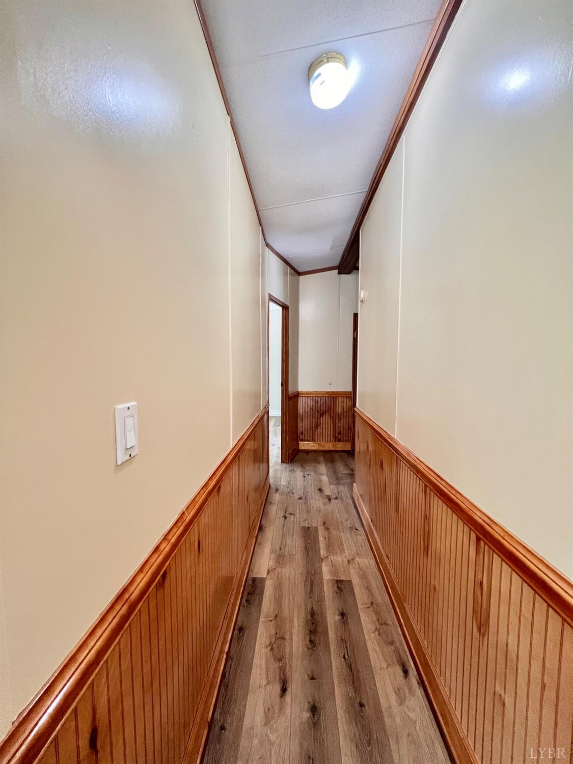 2107 Boxwood Farm Road Amherst, VA 24521 - Photo 12 of 33 a view of a hallway with wooden floor and stairs