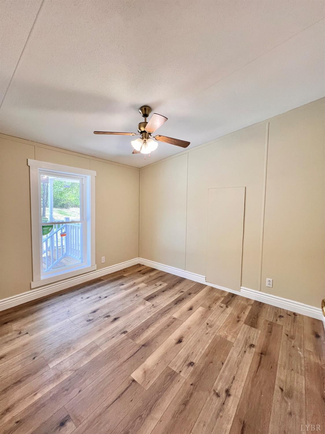 2107 Boxwood Farm Road Amherst, VA 24521 - Photo 4 of 33 a view of an empty room with a window and wooden floor