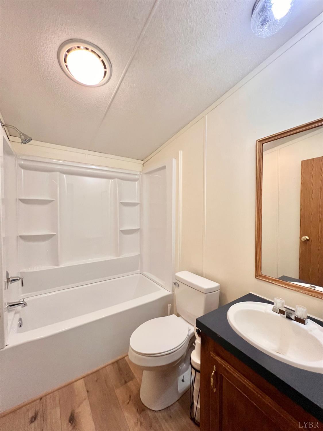 2107 Boxwood Farm Road Amherst, VA 24521 - Photo 5 of 33 a bathroom with a toilet a sink and bathtub