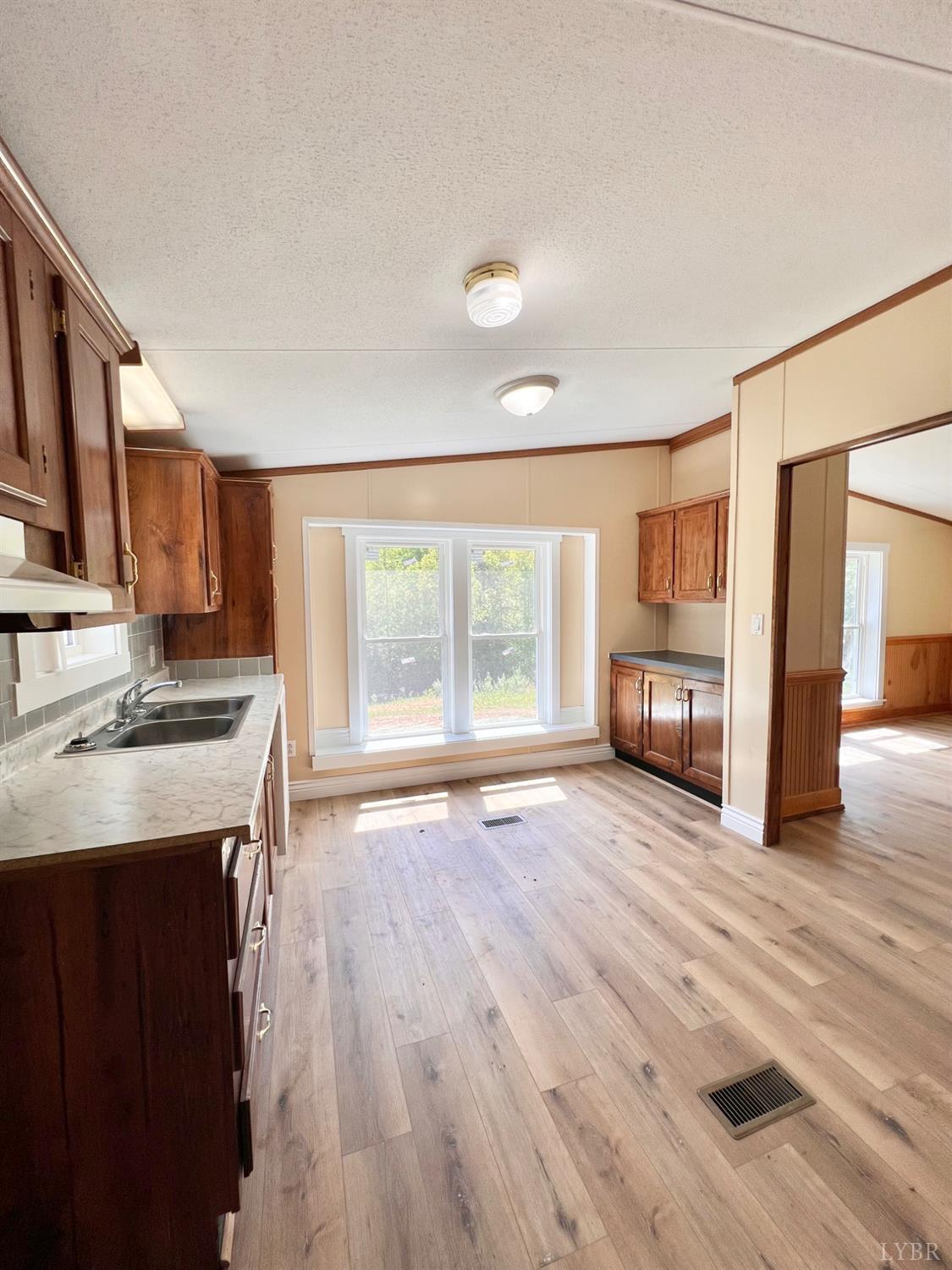 2107 Boxwood Farm Road Amherst, VA 24521 - Photo 8 of 33 a view of kitchen with granite countertop cabinets appliances and a wooden floor