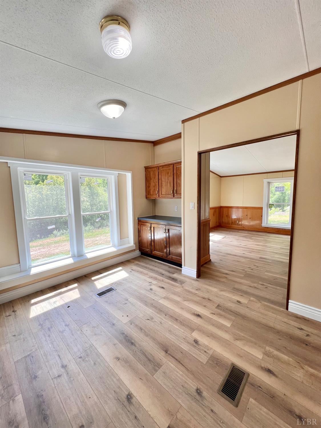 2107 Boxwood Farm Road Amherst, VA 24521 - Photo 9 of 33 a view of empty room with wooden floor and fan