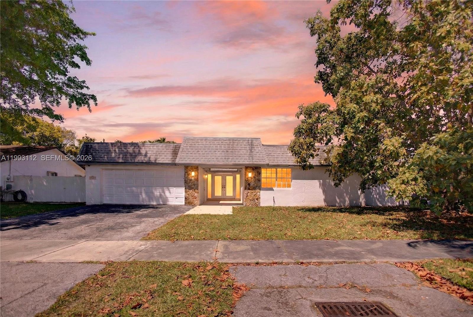 13471 Southwest 99th Terrace Miami, FL 33186 - Photo 1 of 44 a front view of a house with a yard