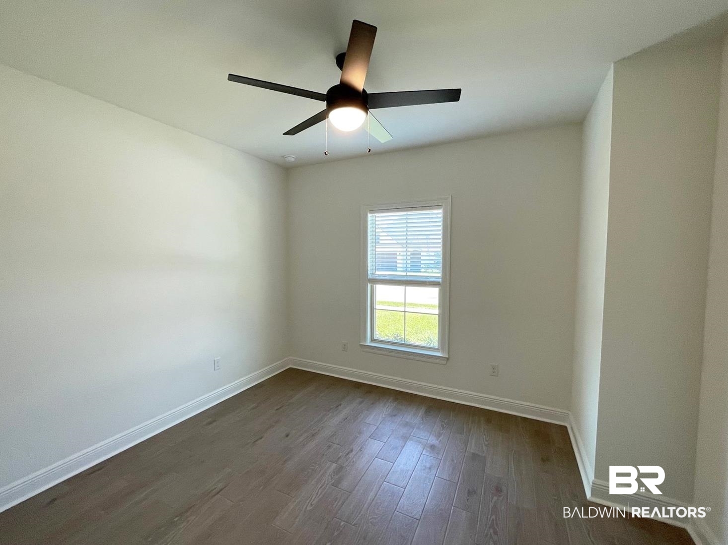 1565 Fenton Circle Foley, AL 36535 - Photo 9 of 15 Unfurnished room featuring ceiling fan and dark hardwood / wood-style flooring