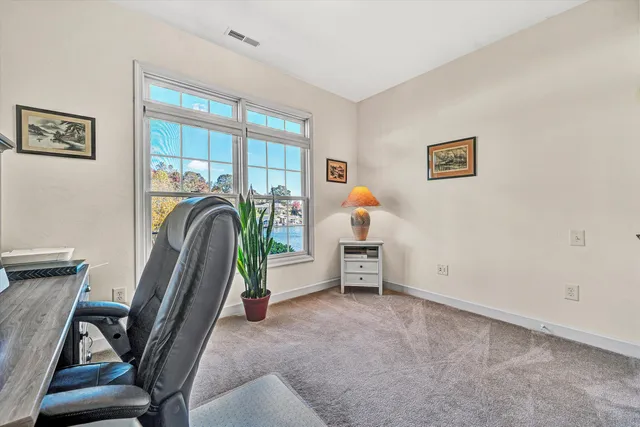 a living room with furniture kitchen view and a window