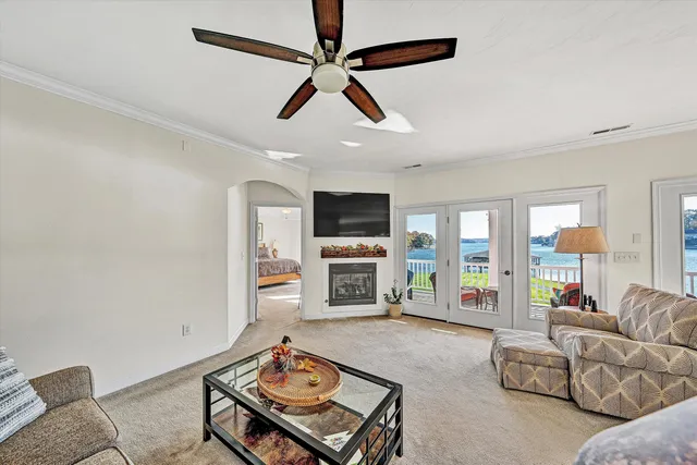a dining room with wooden floor a chandelier a wooden table and chairs