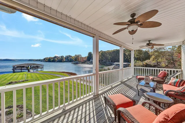 a bedroom with a large bed and a chandelier fan