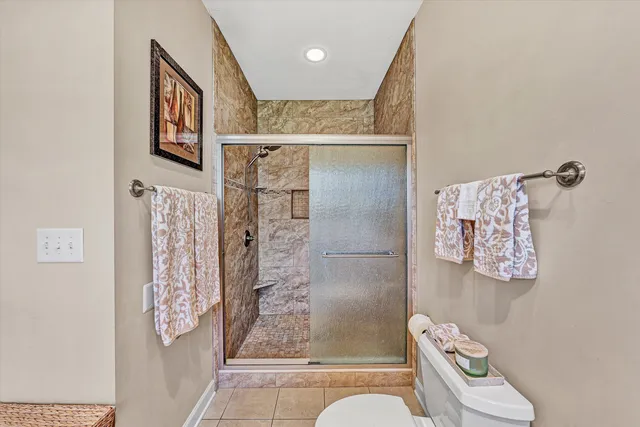 a living room filled with furniture and potted plants