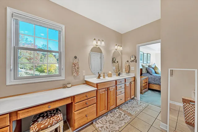 a kitchen with stainless steel appliances granite countertop a stove oven and a refrigerator with white cabinets