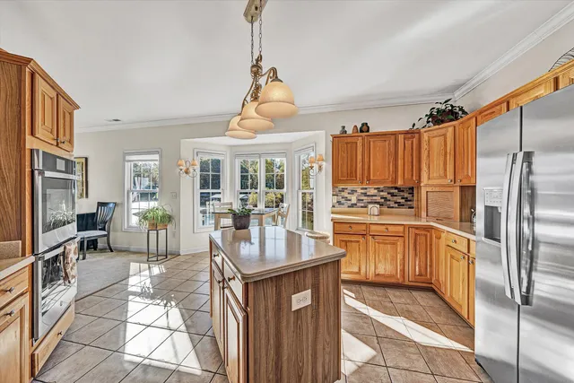 a dining room with furniture and a floor to ceiling window