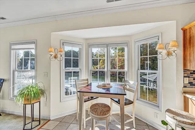 a bedroom with furniture and a large window