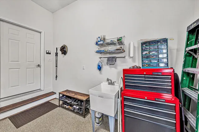 a view of a patio with a table and chairs and wooden fence