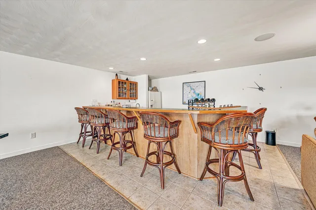 an aerial view of a house with a yard and lake view